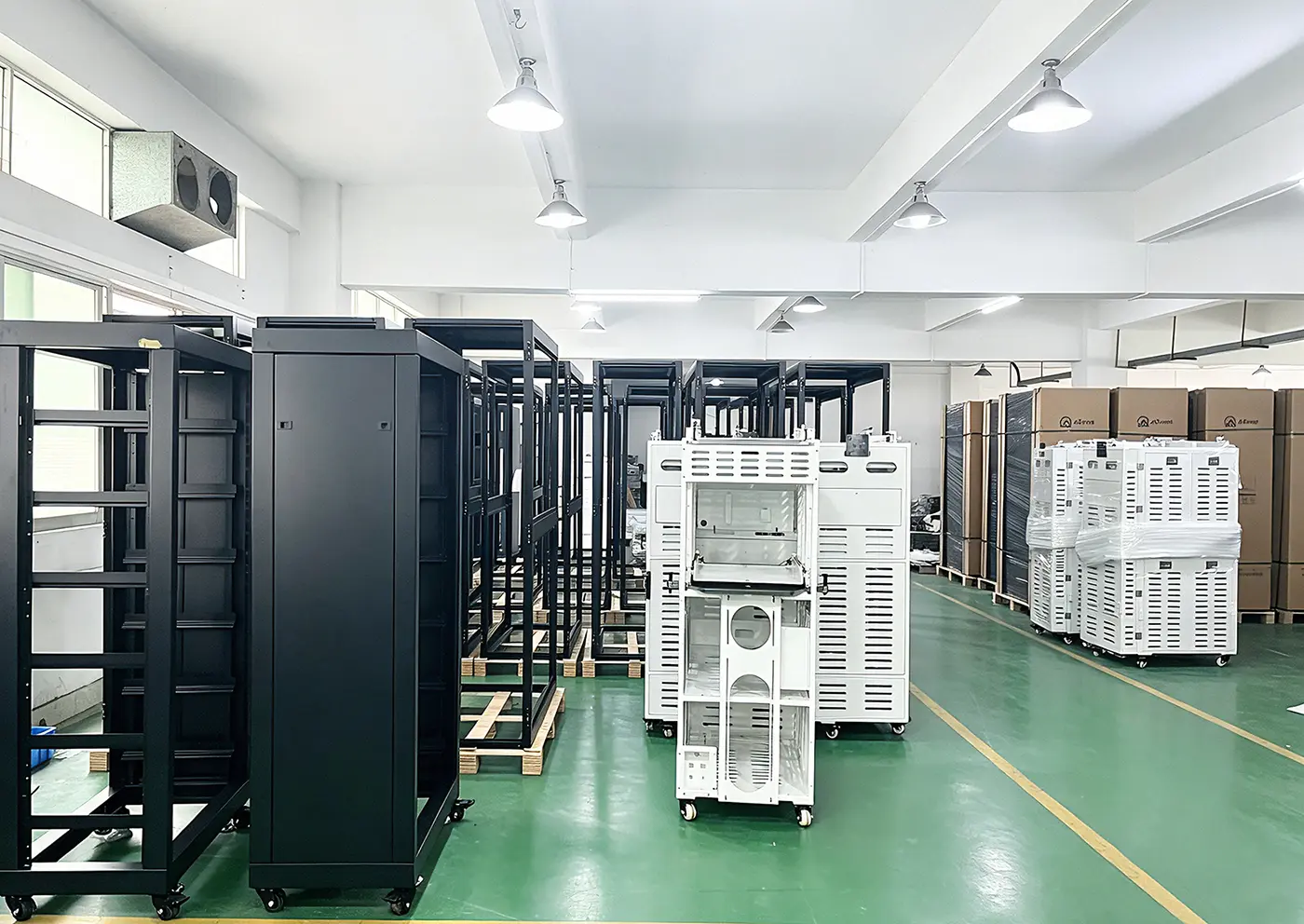 Rows of finished electrical cabinets, server cabinets, and industrial enclosures in our assembly workshop