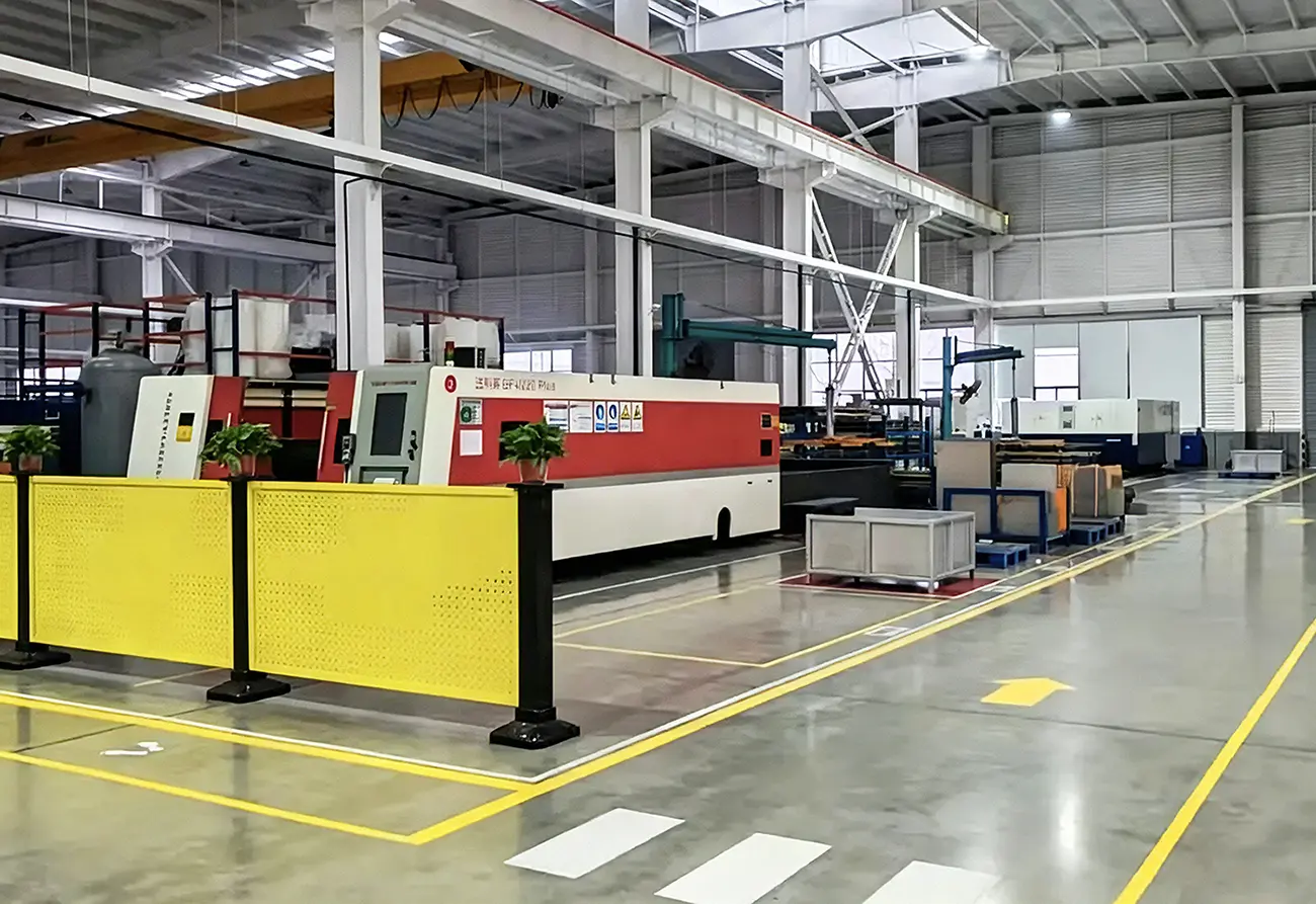 Spacious modern sheet metal fabrication workshop equipped with industrial fiber laser cutting machine and standardized production layout