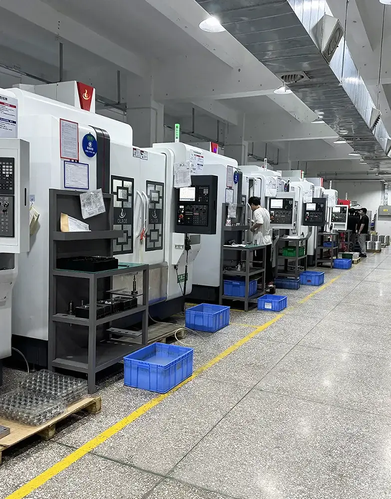 BW factory worker operating CNC machining centers for precision metal parts manufacturing