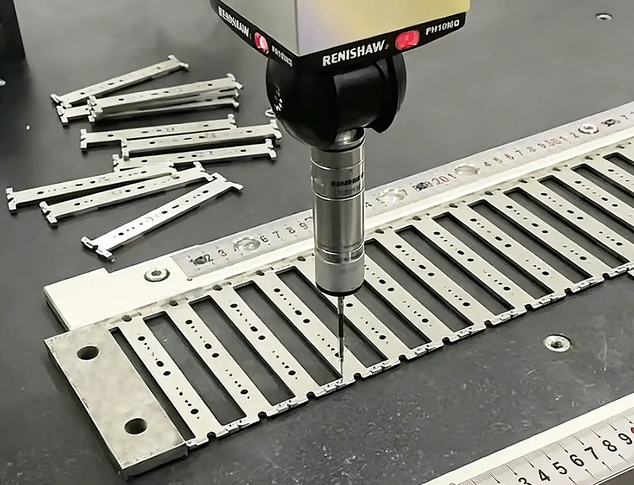 Coordinate Measuring Machine CMM performing full 3D dimensional inspection on custom tight tolerance sheet metal assemblies for manufacturing quality assurance verification