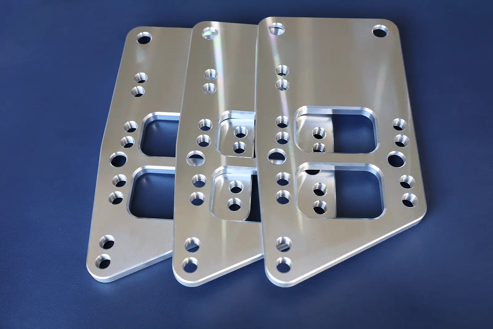 CNC-milled aluminum fixture plate with tapped holes