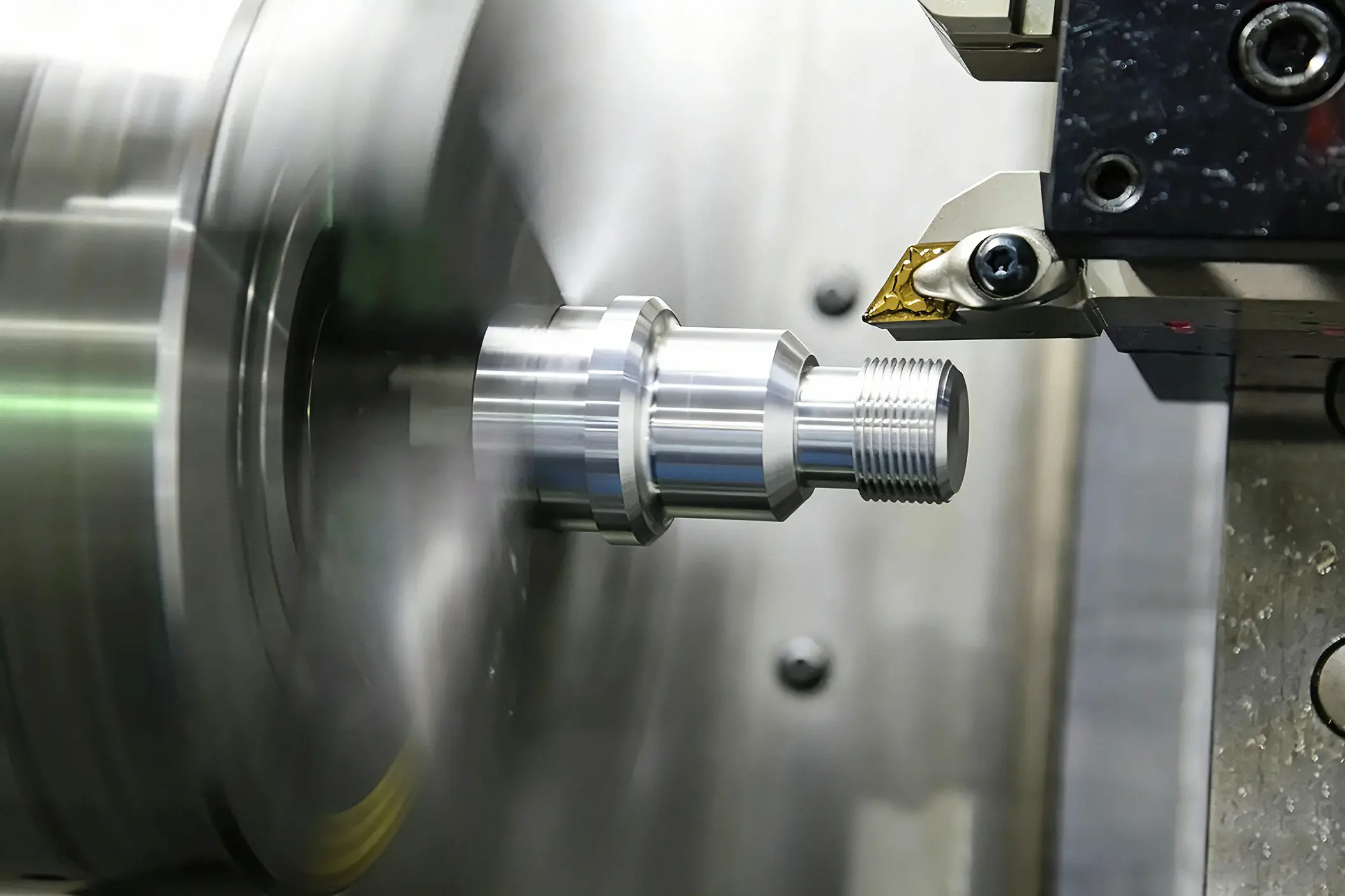Interior of a multiaxis CNC lathe machining a metal part, industrial CNC turning service page banner background for precision machining manufacturing