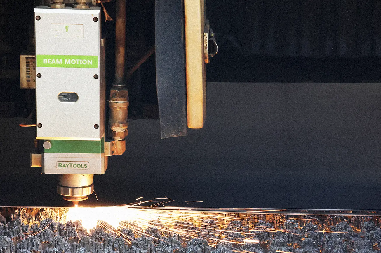 CNC fiber laser cutting machine cutting sheet metal with sparks