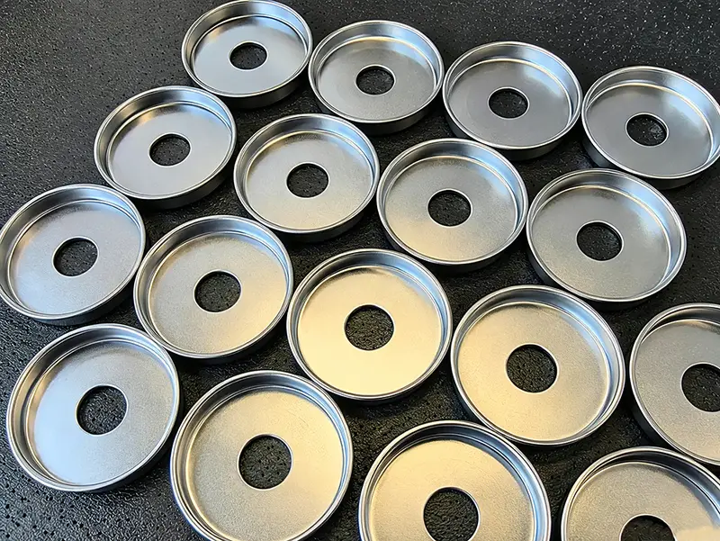 Production batch of stamped metal discs with center holes