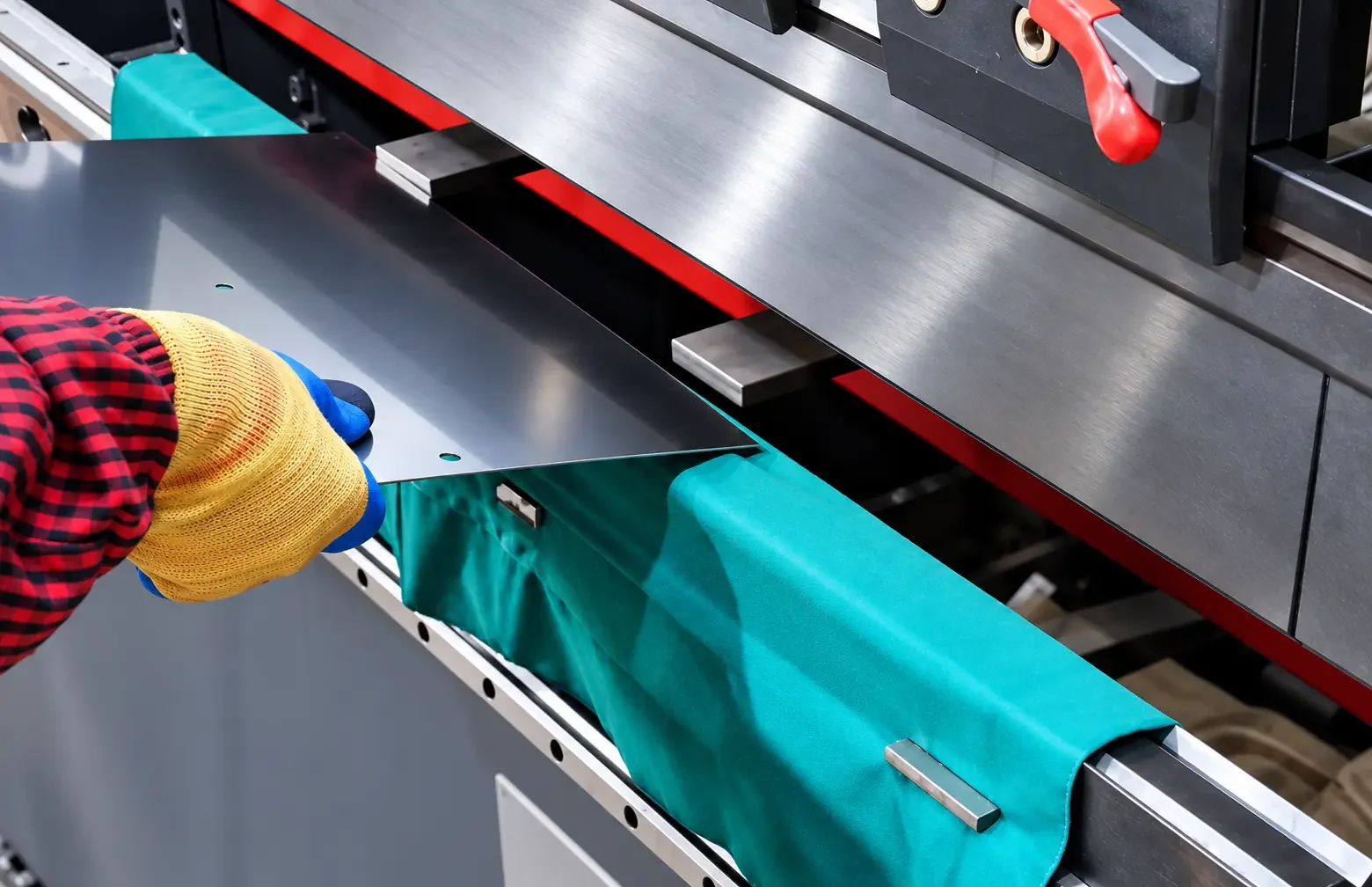 Protective pad placed between sheet metal and press brake lower die