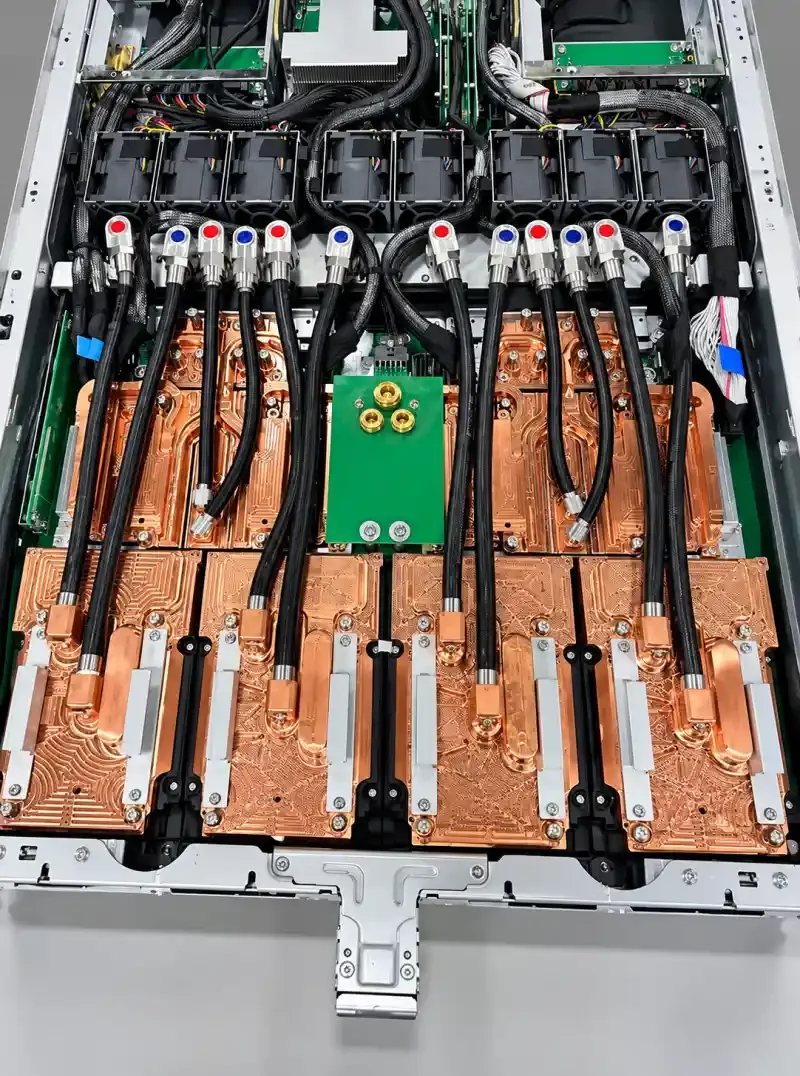 Liquid-cooled server interior with copper cold plates, insulated hoses, quick disconnects, and fans.